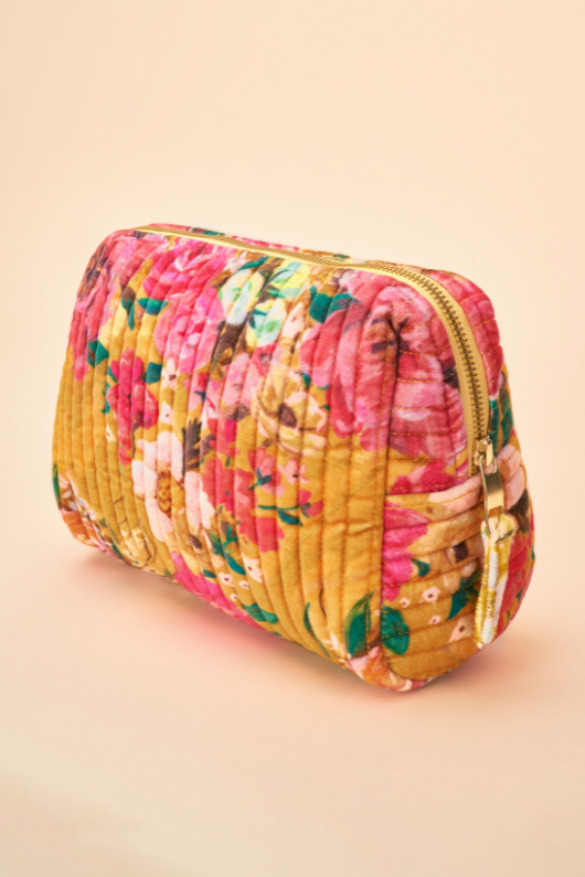 Powder Velvet Wash Bag. A zip-up toiletry bag with a vibrant mustard floral design.