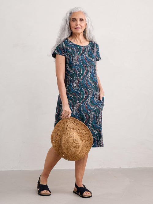 Seasalt River Cove Dress. An A-line dress with scoop neck, short sleeves, zip fastening, and multicoloured wavy print.