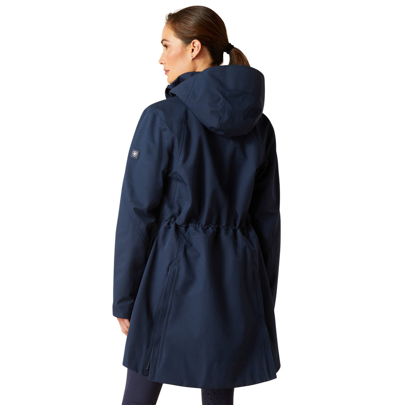 An image of a female model wearing the Ariat Coastal Long H20 Parka Jacket in the colour Navy Eclipse.