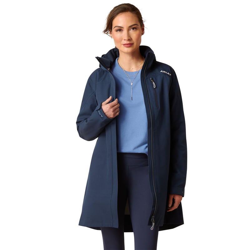 An image of a female model wearing the Ariat Coastal Long H20 Parka Jacket in the colour Navy Eclipse.