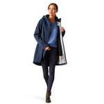 An image of a female model wearing the Ariat Coastal Long H20 Parka Jacket in the colour Navy Eclipse.