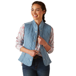 An image of a female model wearing the Ariat Woodside Quilted Gilet in the colour Blue Shadow.