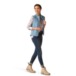 An image of a female model wearing the Ariat Woodside Quilted Gilet in the colour Blue Shadow.