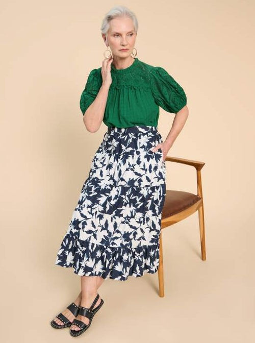 White Stuff Mayra Print Midi Skirt. A midi length tiered skirt with pockets, in a navy/white bold print.