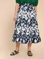 White Stuff Mayra Print Midi Skirt. A midi length tiered skirt with pockets, in a navy/white bold print.