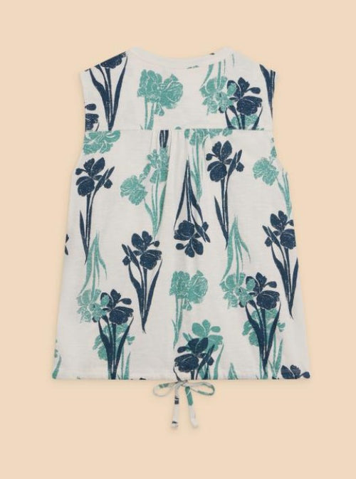 White Stuff Tulip Jersey Sleeveless Shirt. A regular fit, sleeveless shirt with notch neck, tie hem, and floral patterned embroidery in shades of blue.