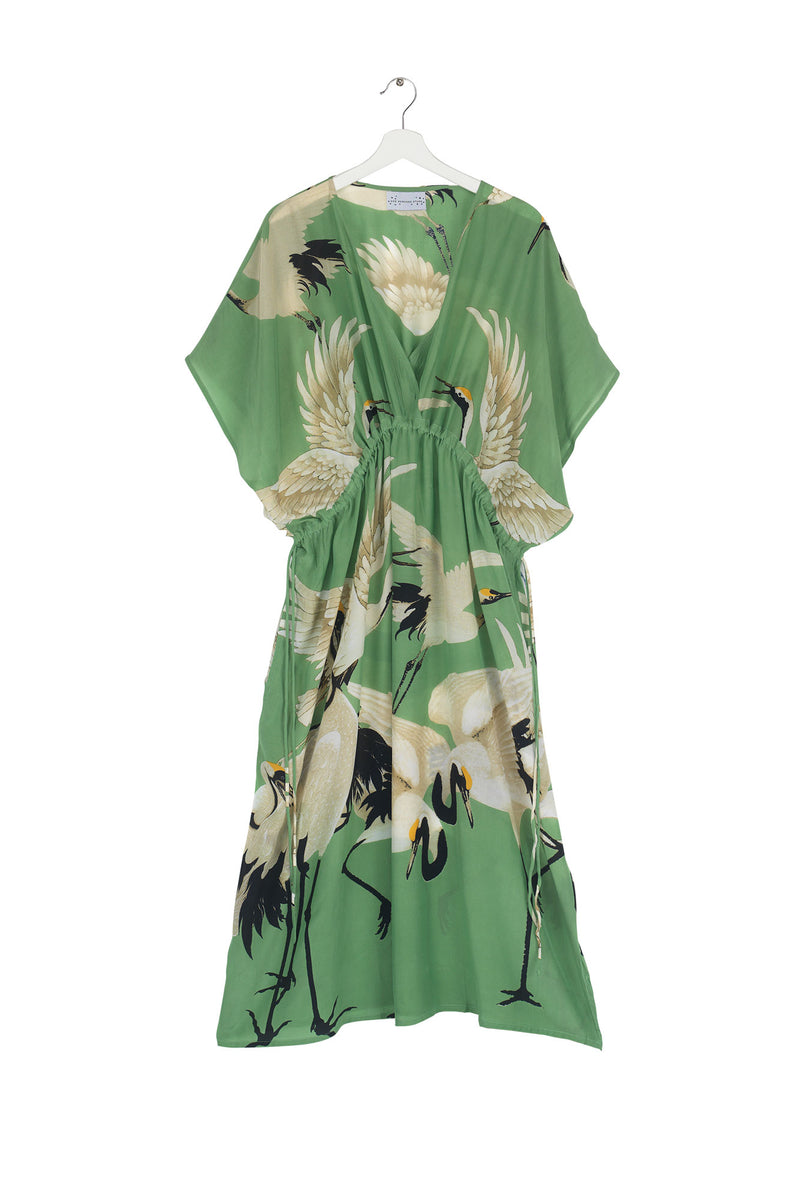 One Hundred Stars Stork Pea Green String Dress. A midi-length summer dress with a Grecian shape, V-neck, and a bright green & stork design