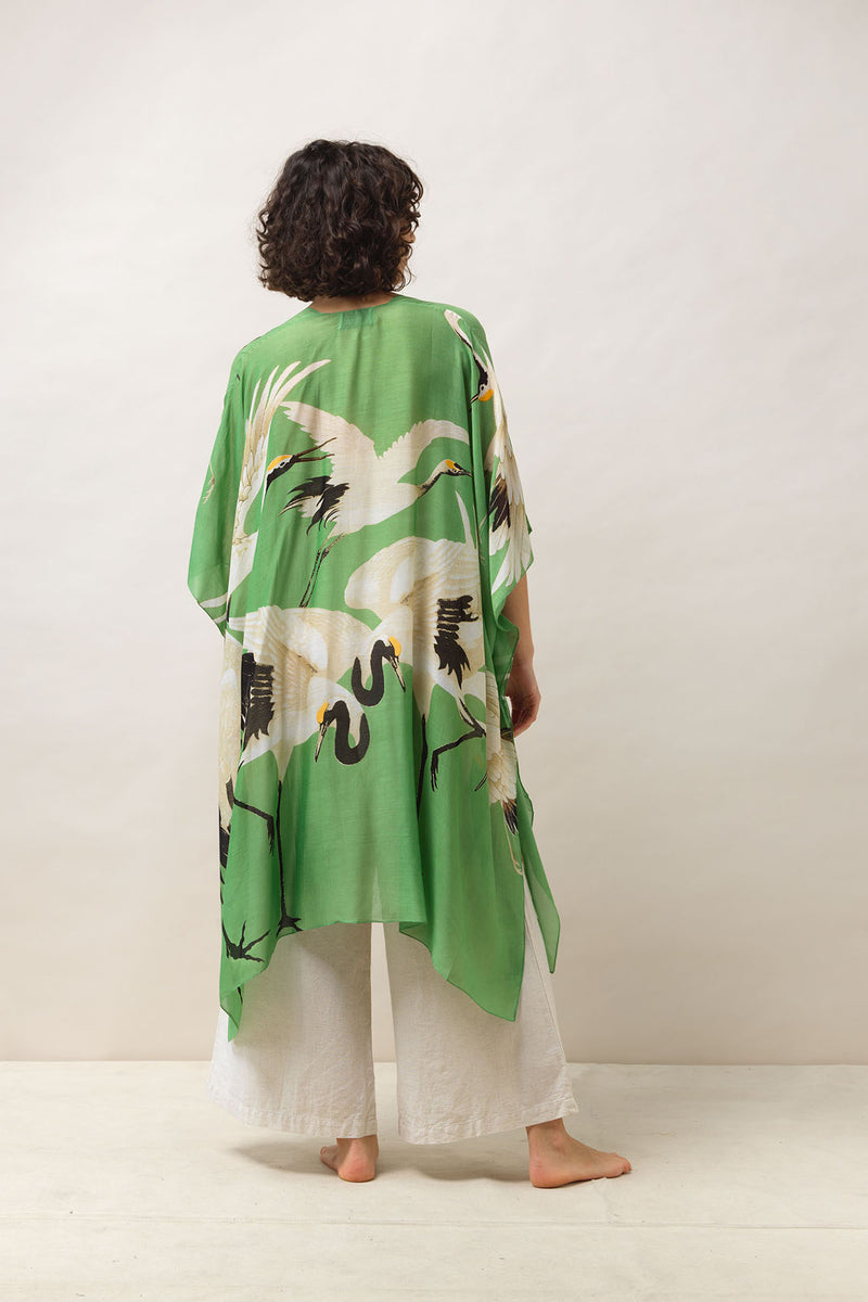 One Hundred Stars Throwover. A lightweight, shoulder cover up with an intricate green design.
