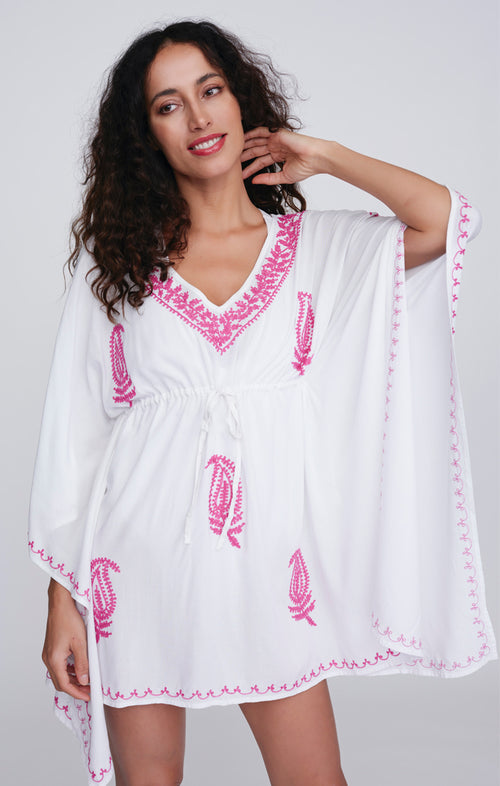 Pia Rossini Tulsa Cover Up. A midi-length cover up with V-neck, drawstring waist, V-neck and embroidery. This cover up is white with pink embroidery.