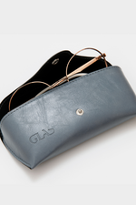 GLAS Vegan Leather Case. A vegan leather glasses case with button closure in the shade dusty blue.