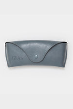 GLAS Vegan Leather Case. A vegan leather glasses case with button closure in the shade dusty blue.