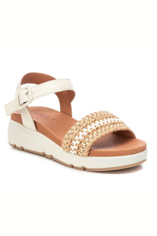 Carmela Low Wedge Sandal. A pair of beige and white leather sandals with braided design and sports style non-slip sole.