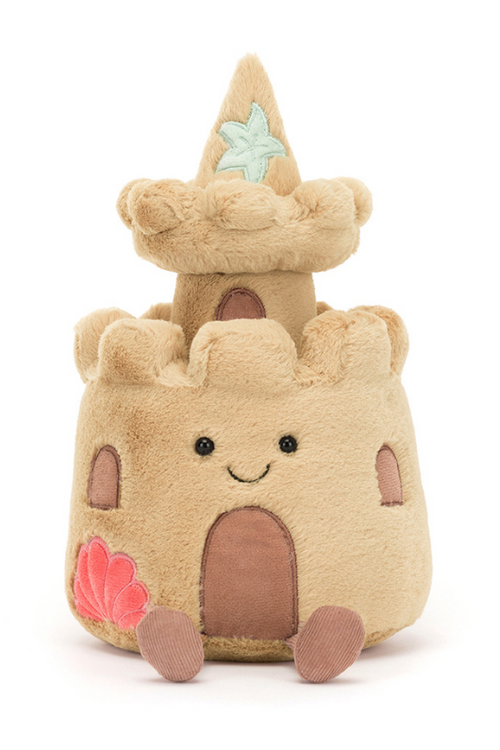 Jellycat Amuseable Sandcastle. A soft toy sandcastle with smiling face, sand coloured fur, and seashell details.