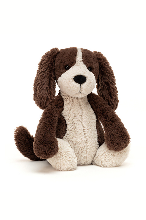 Jellycat Bashful Fudge Puppy. A cuddly toy dog with brown and white fur, floppy ears and long tail.