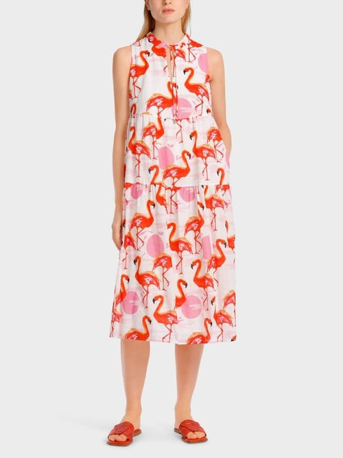 Marc Cain Flamingo Tiered Dress. A midi length sleeveless dress with tie neck, cut-out detail and pink/red flamingo print.