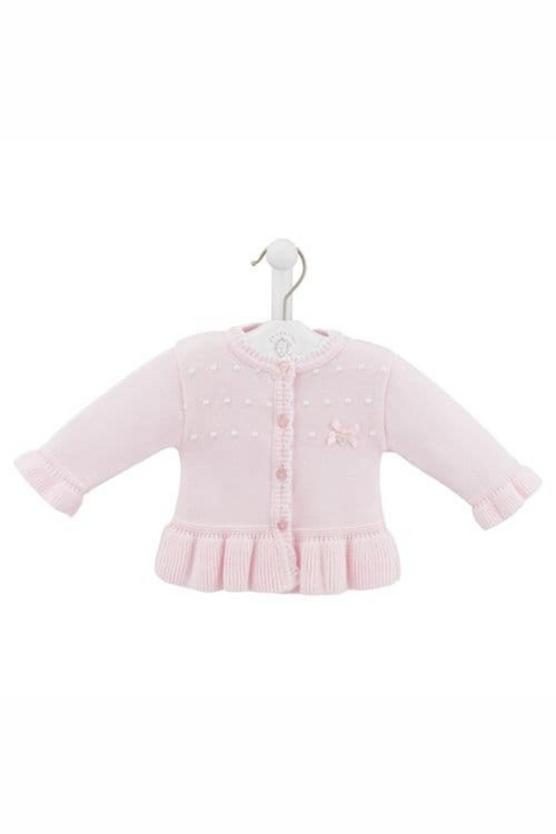 Dandelion Cotton Ruffle Cardigan. A long sleeve cardigan with ruffle hem, bow detail, and heart shaped buttons. This cardigan is made from a fine knit cotton in the colour pink.