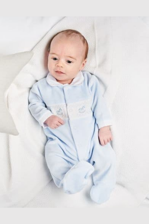Dandelion Velour Smocked Rocking Horse Sleepsuit. A long sleeve jumpsuit with peter pan collar, smocked detail and rocking horse embroidery in a blue velour material.