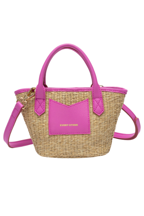 Every Other Straw Rattan Grab Bag. A small raffia bag with pink faux leather details, top handles, crossbody strap, and fully lined interior with zip pocket.