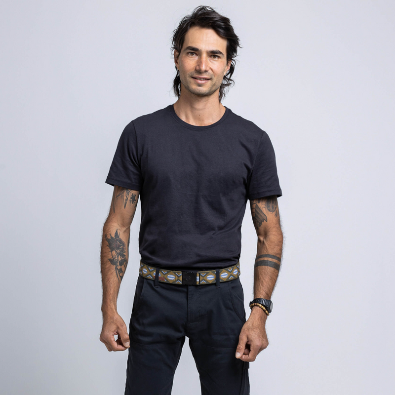 An image of a male model wearing the Arcade Belts Creosote Belt in the colour Tumblewood.