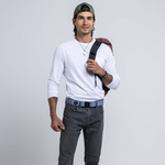 An image of a male model wearing the Blackwood Belt by Arcade Belts in the colour Sky Ivy Green.