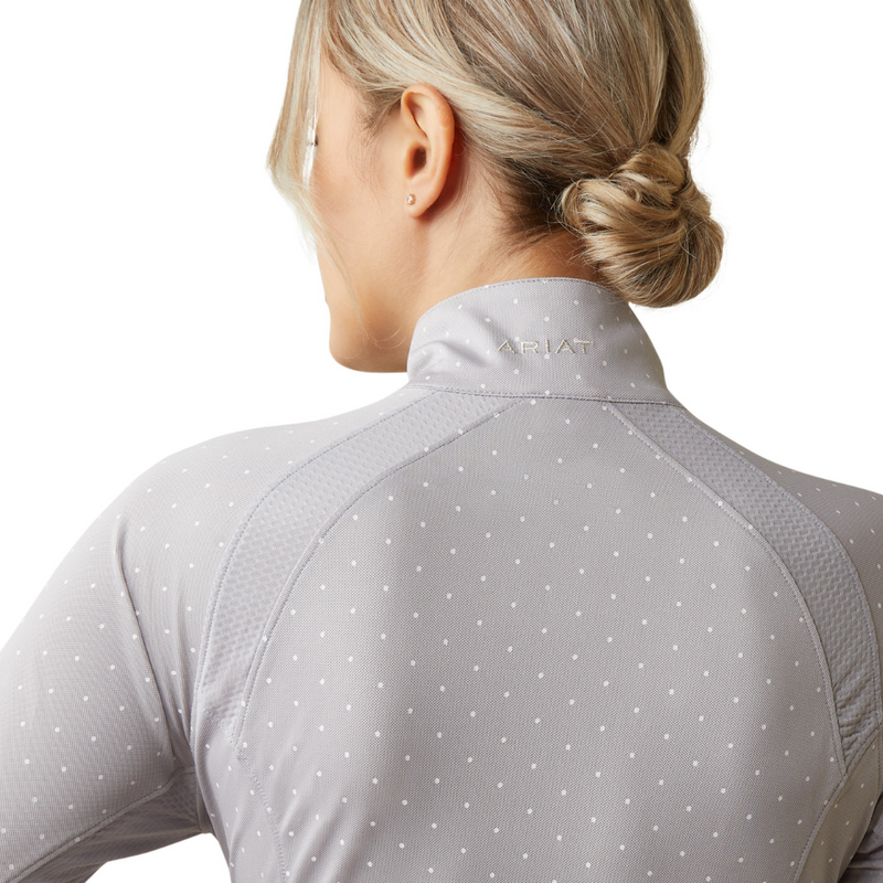 An image of a female model wearing the Ariat Sunstopper 2.0 1/4 Zip Baselayer in the colour Silver Sconce Dot.