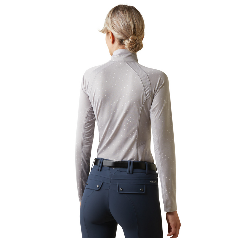 An image of a female model wearing the Ariat Sunstopper 2.0 1/4 Zip Baselayer in the colour Silver Sconce Dot.